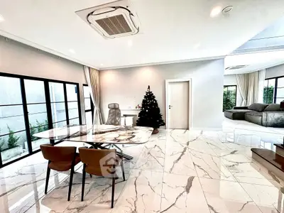 Luxurious open-plan living room with marble floors and modern furniture