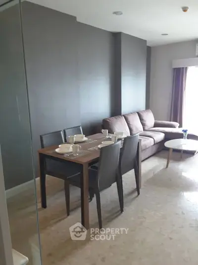 Modern living room with dining area and cozy sofa in stylish apartment