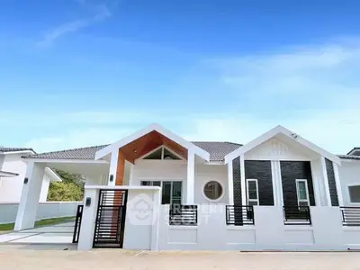 Modern single-story house with unique roof design and gated entrance