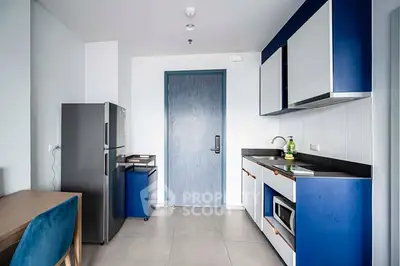 Modern kitchen with sleek blue cabinets and stainless steel appliances