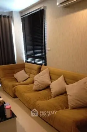 Cozy living room with plush yellow sofas and modern decor