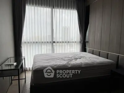 Modern bedroom with large window and minimalist design