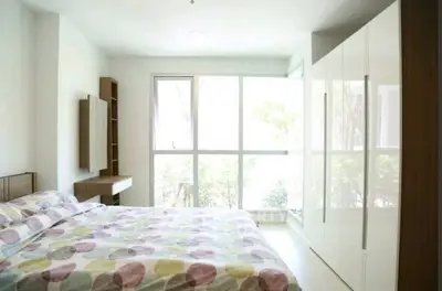 Bright and airy bedroom with large window and modern wardrobe