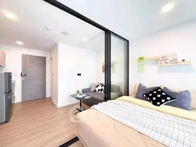 Modern studio apartment with cozy bedroom and stylish living area, featuring sleek design and natural light.