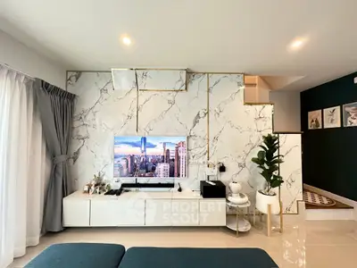 Luxurious modern living room with marble accent wall and sleek entertainment center.