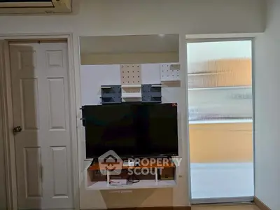 Modern living room with wall-mounted TV and sleek storage solutions