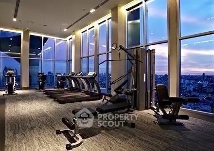 Luxurious high-rise gym with panoramic city views and modern fitness equipment.