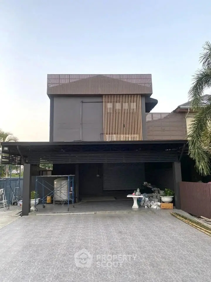 Modern two-story house with sleek design and spacious driveway, perfect for contemporary living.