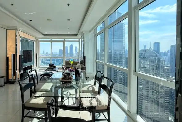 Luxurious corner unit with panoramic city views and spacious dining area.