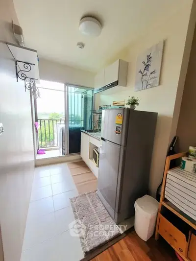 Charming compact kitchen with balcony view, featuring modern appliances and stylish decor.