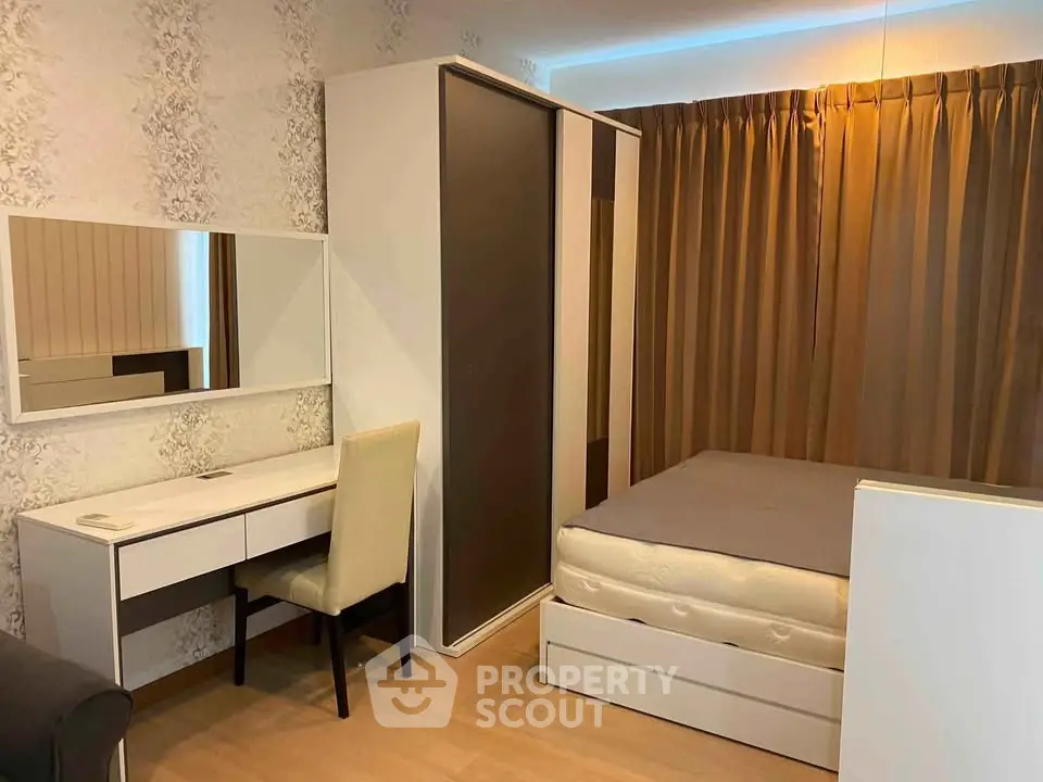 Cozy bedroom with modern furniture and ample storage space in a stylish apartment.