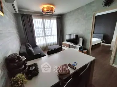 Modern living room with stylish decor and adjacent bedroom view