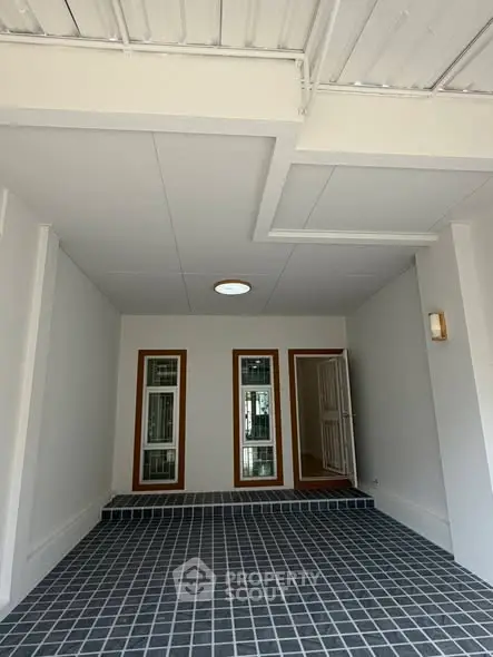 Modern entrance with sleek tiled flooring and contemporary design