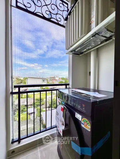 Charming balcony with laundry area and scenic view, perfect for urban living convenience.