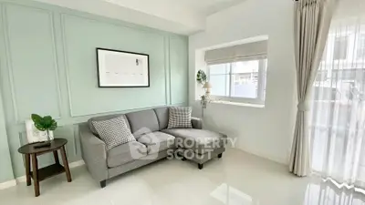 Bright and modern living room with stylish gray sofa and elegant decor.
