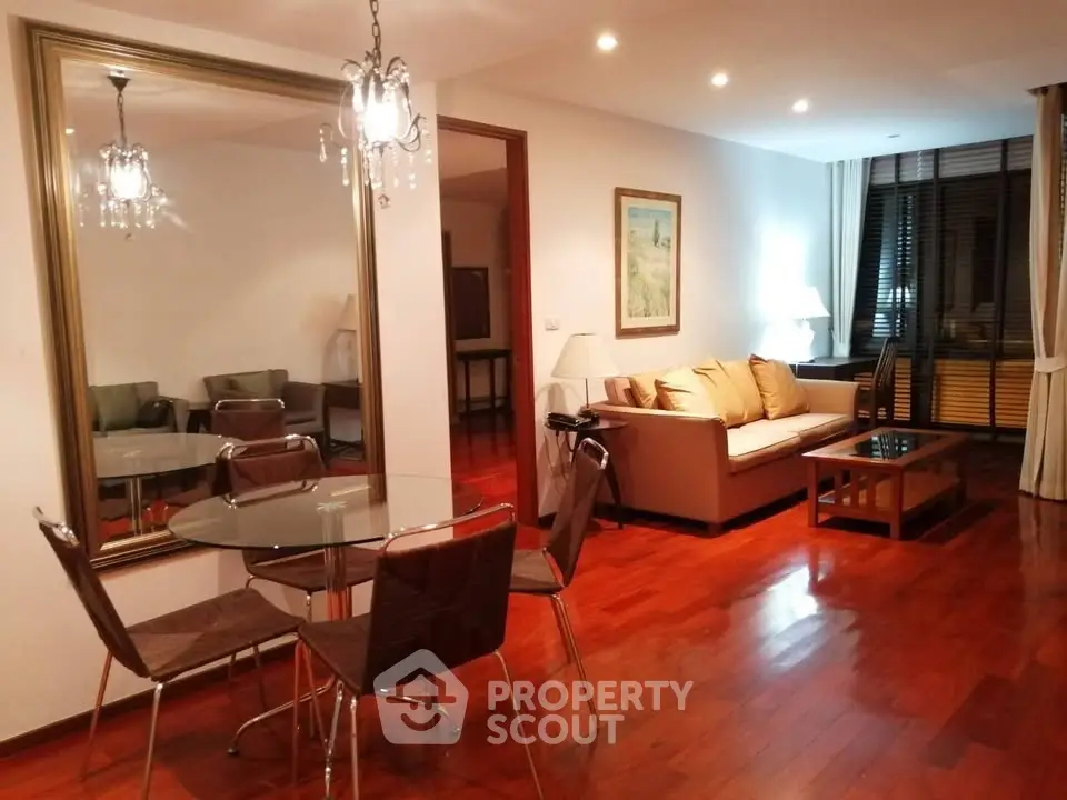 Spacious living room with elegant decor and hardwood floors in modern apartment.