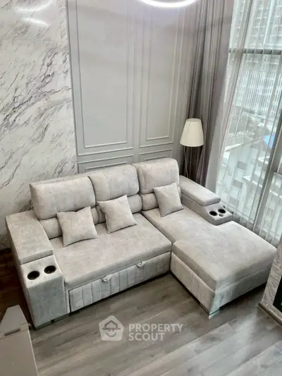 Luxurious modern living room with elegant marble walls and plush sectional sofa.