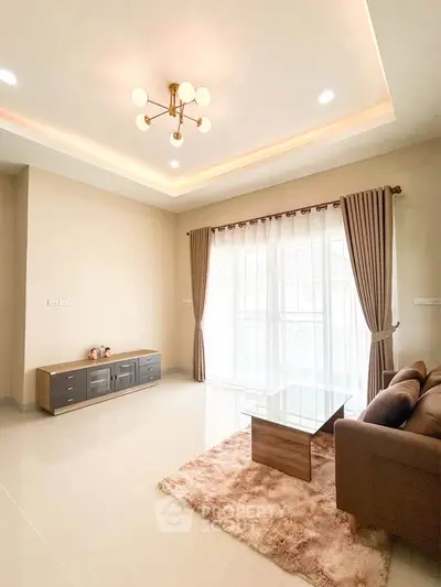 Spacious living room with modern lighting and large windows