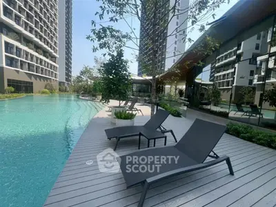 Luxurious apartment complex with stunning poolside area and modern architecture.