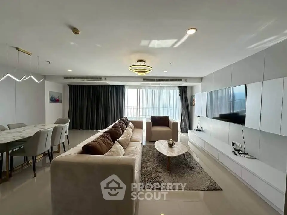 Spacious modern living room with elegant decor and large windows for natural light.