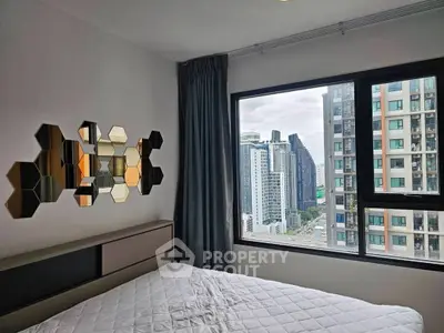 Modern bedroom with city view and stylish hexagonal wall decor