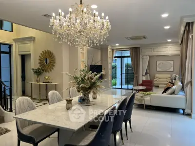 Luxurious living room with elegant chandelier and marble dining table