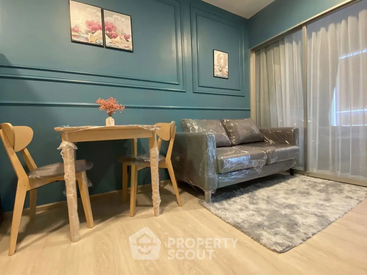Chic living room with modern decor, cozy sofa, and elegant dining set in a stylish apartment.
