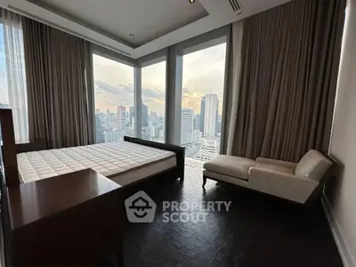 Luxurious bedroom with panoramic city view and elegant furnishings.