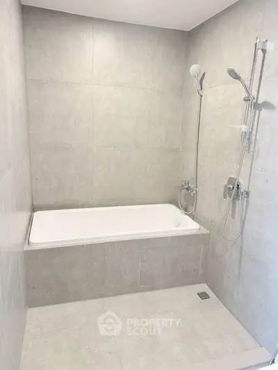 Modern bathroom with sleek gray tiles and dual shower heads