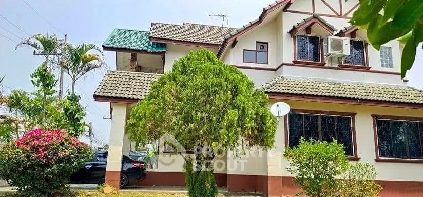 Charming suburban house with lush garden and classic architecture.