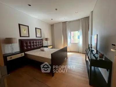 Spacious bedroom with elegant decor and natural light