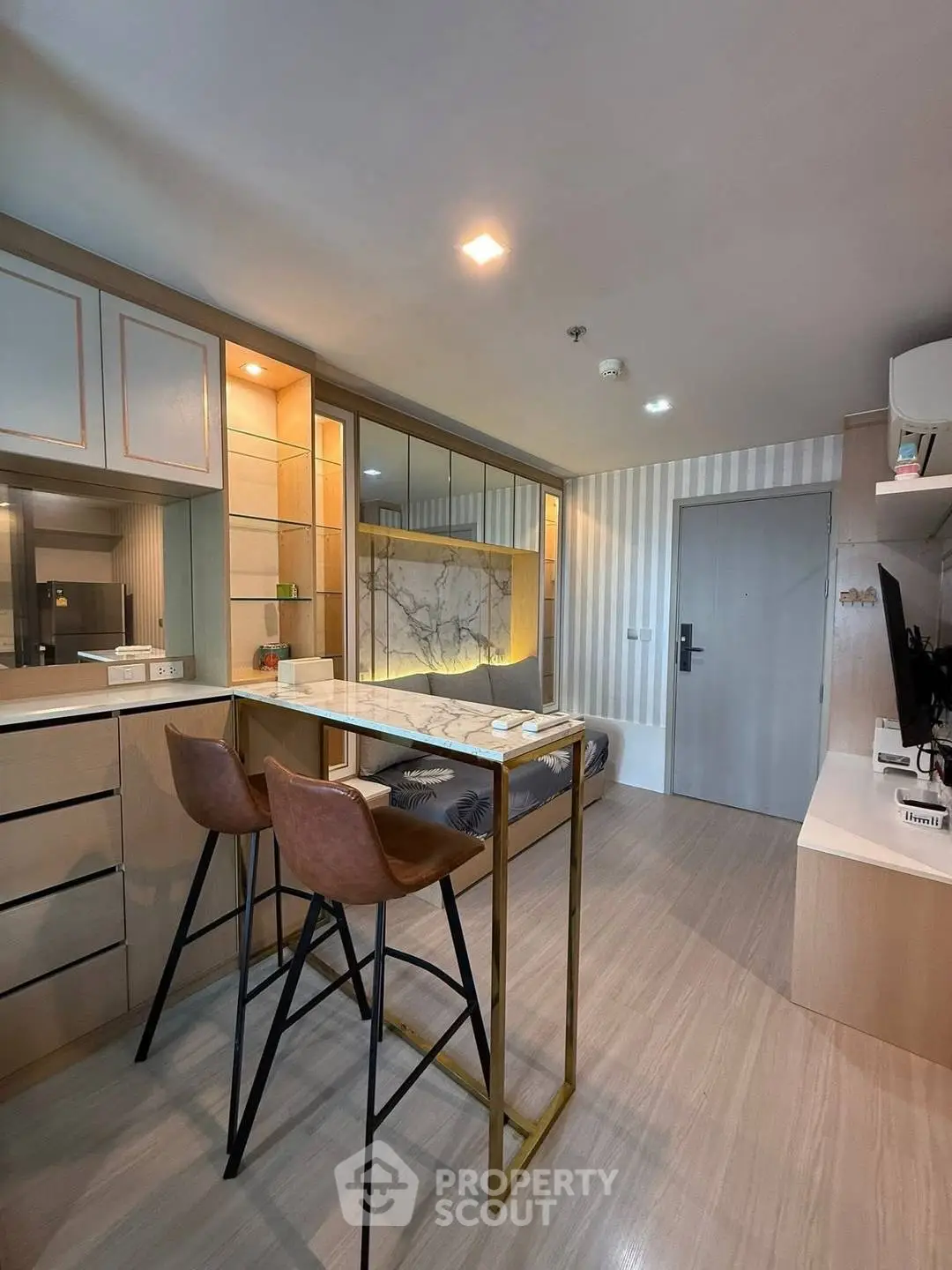 Modern living room with stylish decor and open layout, featuring a cozy seating area and sleek furniture.