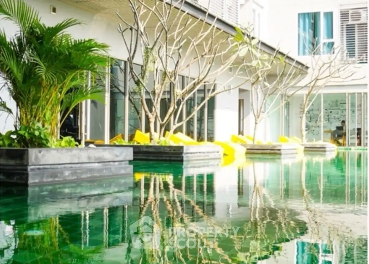 Luxurious poolside view with lush greenery and modern architecture