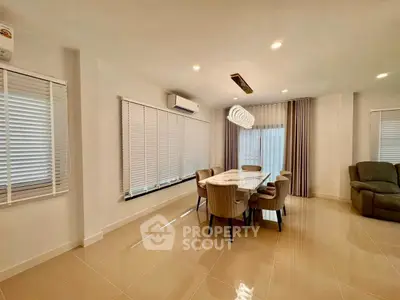 Spacious modern living room with elegant dining area and stylish lighting.
