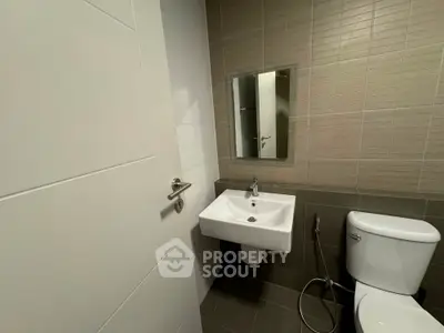 Modern bathroom with sleek sink and toilet in contemporary design.