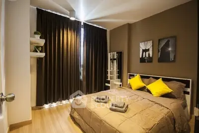 Cozy bedroom with modern decor and warm lighting, featuring a comfortable bed and stylish wall art.