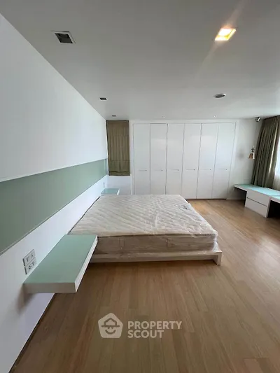 Spacious modern bedroom with built-in wardrobes and minimalist design