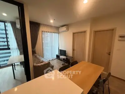 Modern living room with dining area and large windows in a stylish apartment