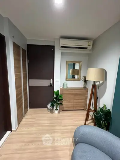 Modern apartment entrance with stylish decor and wooden flooring