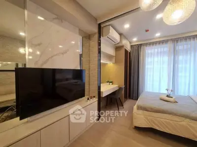 Modern bedroom with stylish decor, featuring a TV, study area, and large windows for natural light.