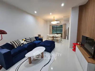 Modern living room with stylish blue sofa and elegant dining area
