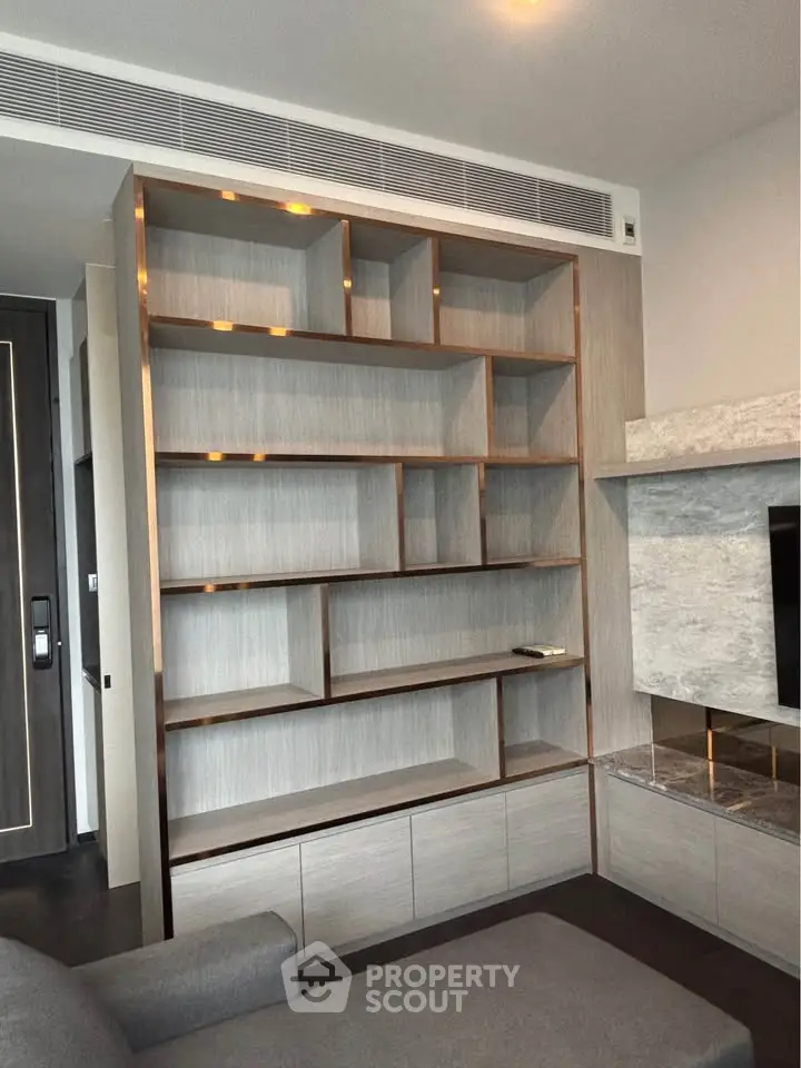 Modern living room with stylish built-in wooden shelves and sleek design.
