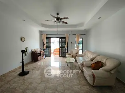 Spacious living room with elegant furniture and large windows for natural light.