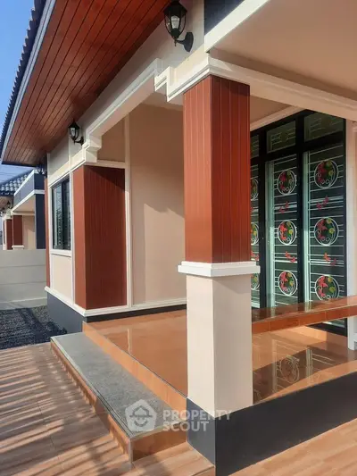 Modern house exterior with stylish wooden accents and elegant entrance design.