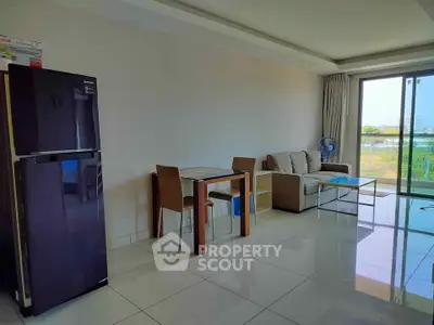 Modern living room with sleek furniture and large windows offering a scenic view.