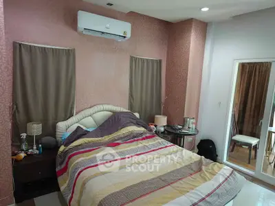 Cozy bedroom with stylish decor and air conditioning, perfect for relaxation and comfort.