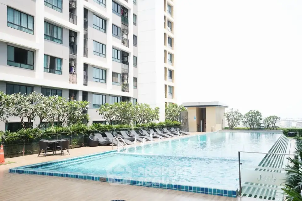 Luxurious apartment complex with a stunning outdoor pool and modern amenities.