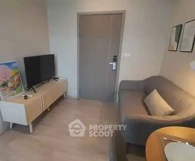 Cozy living room with modern decor and flat-screen TV, perfect for relaxation.