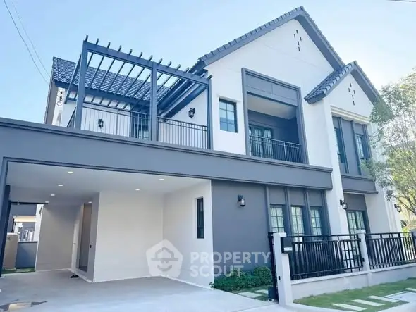 Stunning modern two-story house with elegant facade and spacious driveway.