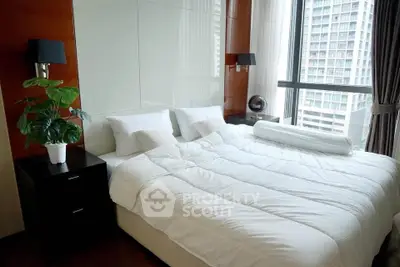 Luxurious bedroom with city view, featuring a king-size bed and modern decor in a high-rise apartment.